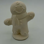 Unpainted gingerbread man figurine on a white background