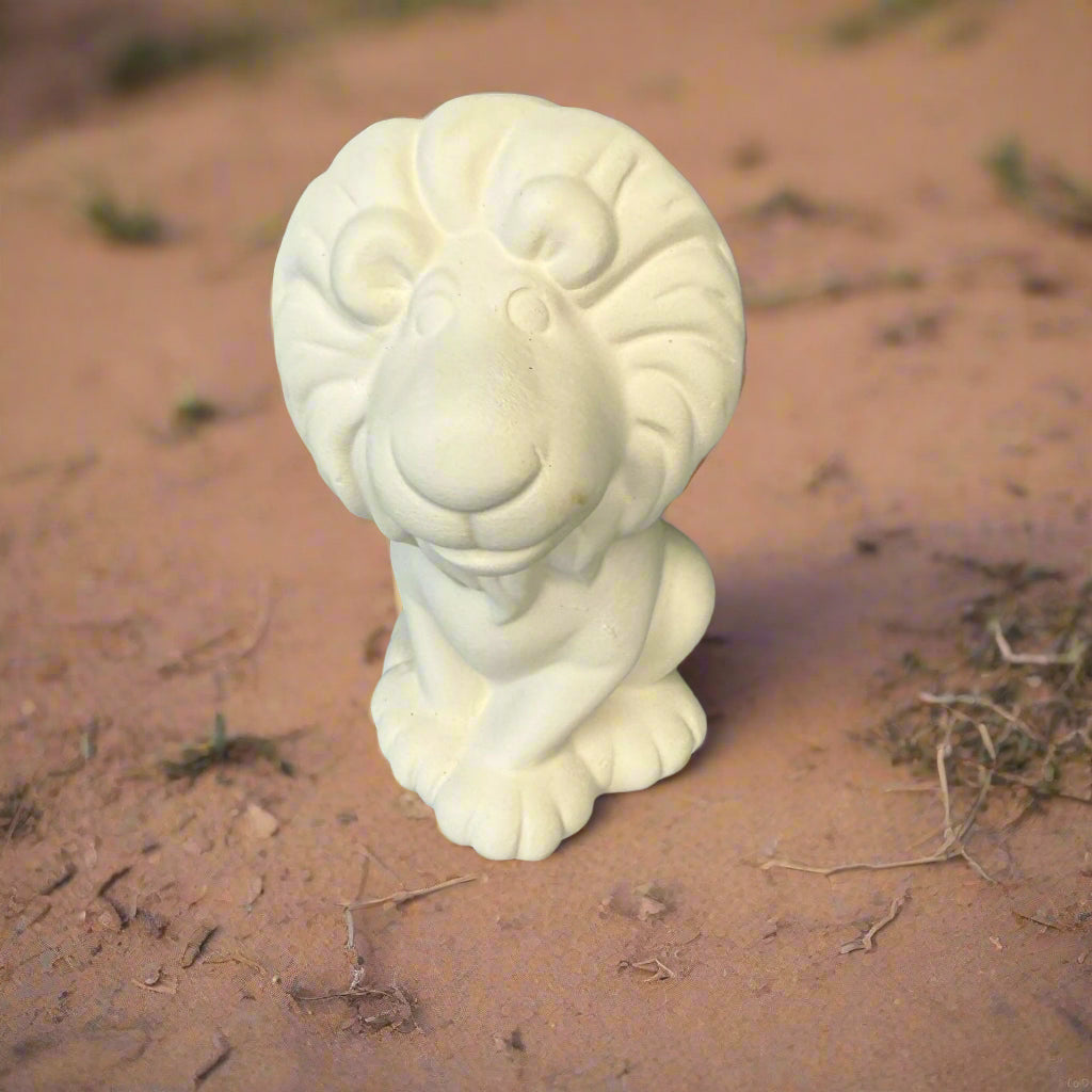 White ceramic ram head sculpture on a wooden surface