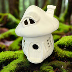 White ceramic birdhouse on a wooden surface with a rustic background