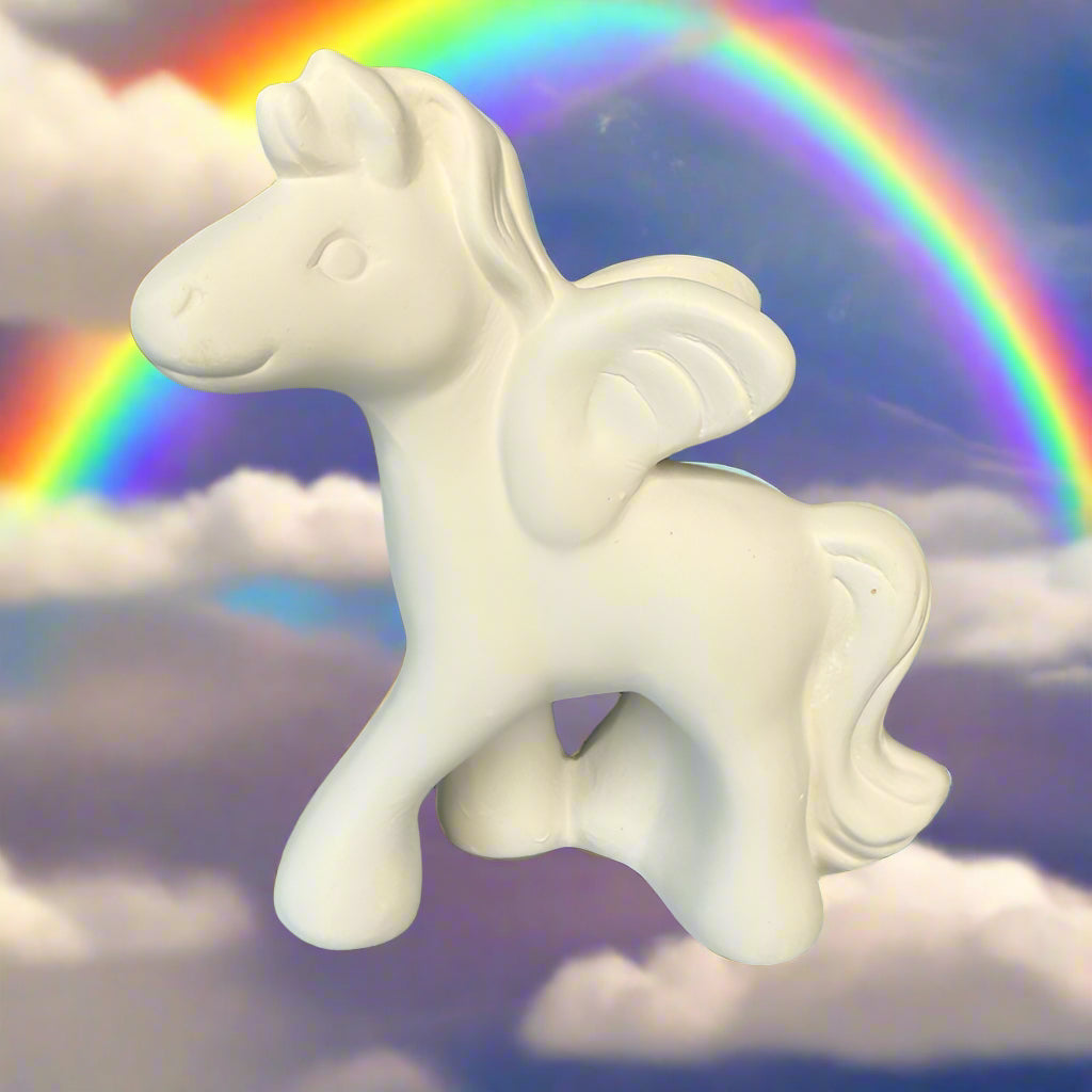 White ceramic unicorn figurine on a wooden surface