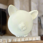 White ceramic piggy bank on a gray background