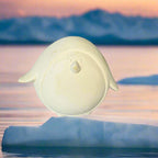 White ceramic dish with handles on a rustic wooden surface