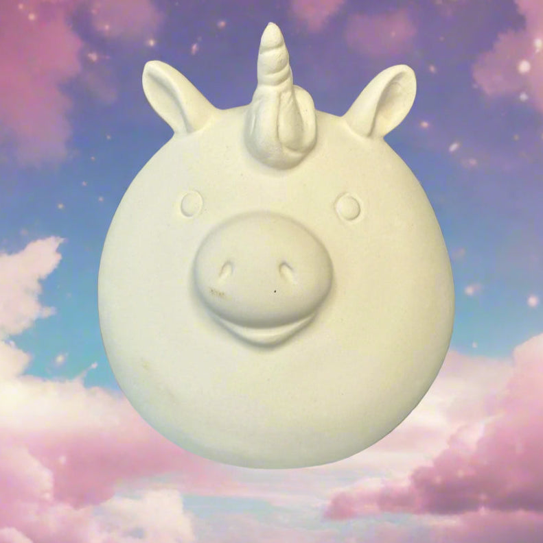 White unicorn-shaped object on a wooden surface