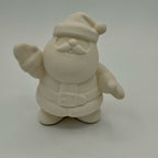 Unpainted ceramic Santa Claus figurine on a white background