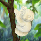 Unpainted ceramic sculpture of a bird on a wooden surface