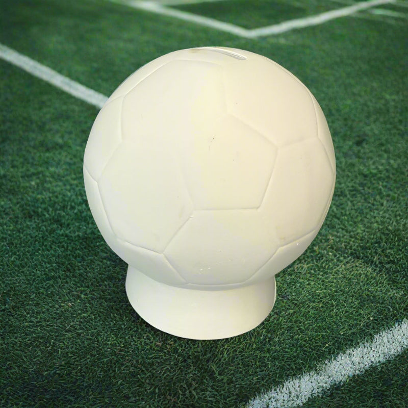 White soccer ball on a rustic wooden surface