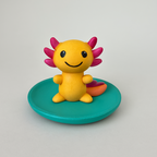 Colorful axolotl figurine on a green base against a gray background