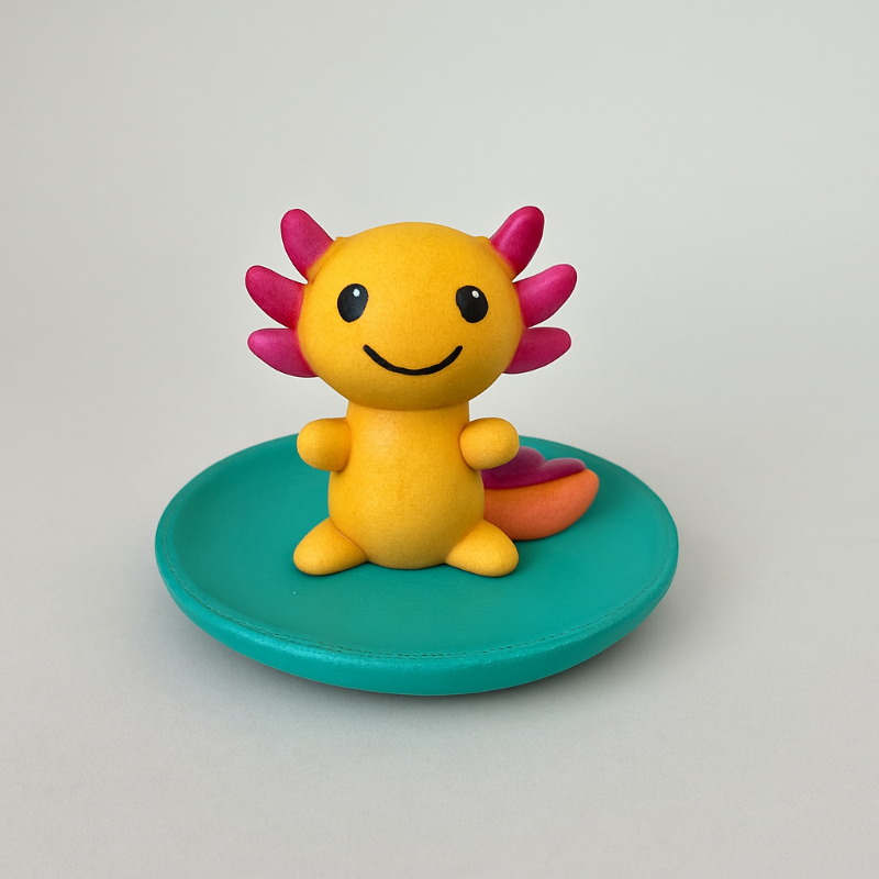 Colorful axolotl figurine on a green base against a gray background