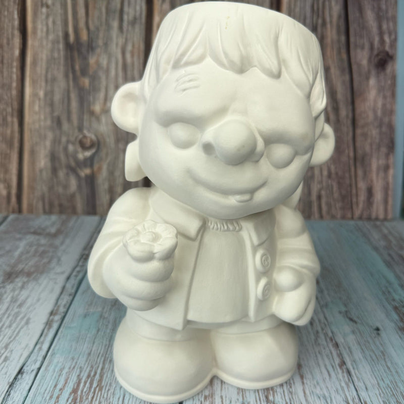 White ceramic gnome figurine on a wooden surface