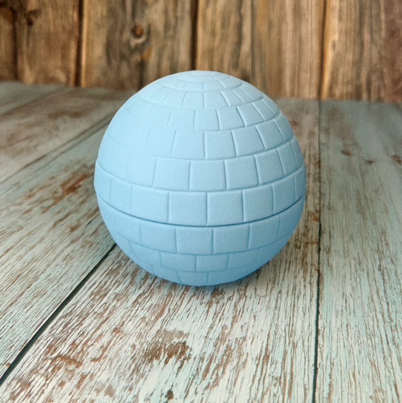 Blue textured sphere on a wooden surface with a wooden background