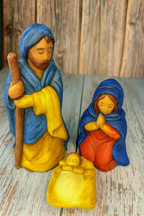 ceramic nativity scene figures on a wooden surface