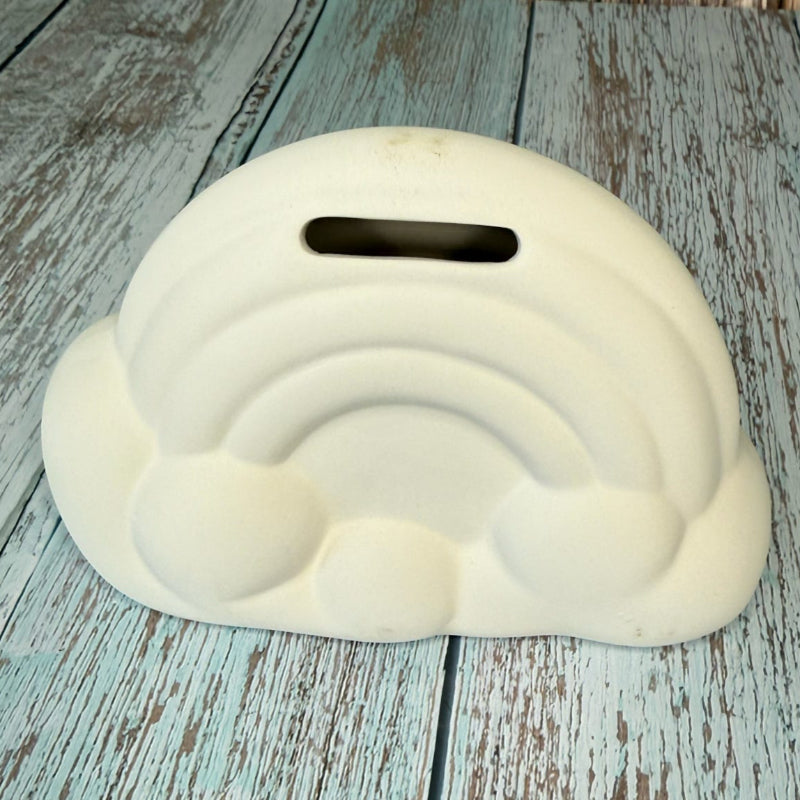 White cloud-shaped object on a wooden surface