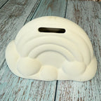 White cloud-shaped object on a wooden surface