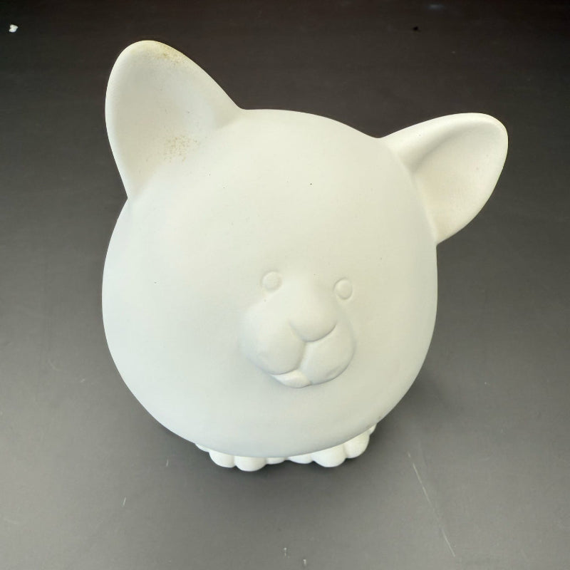 White ceramic piggy bank on a gray background