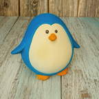 Penguin-shaped object on a wooden surface