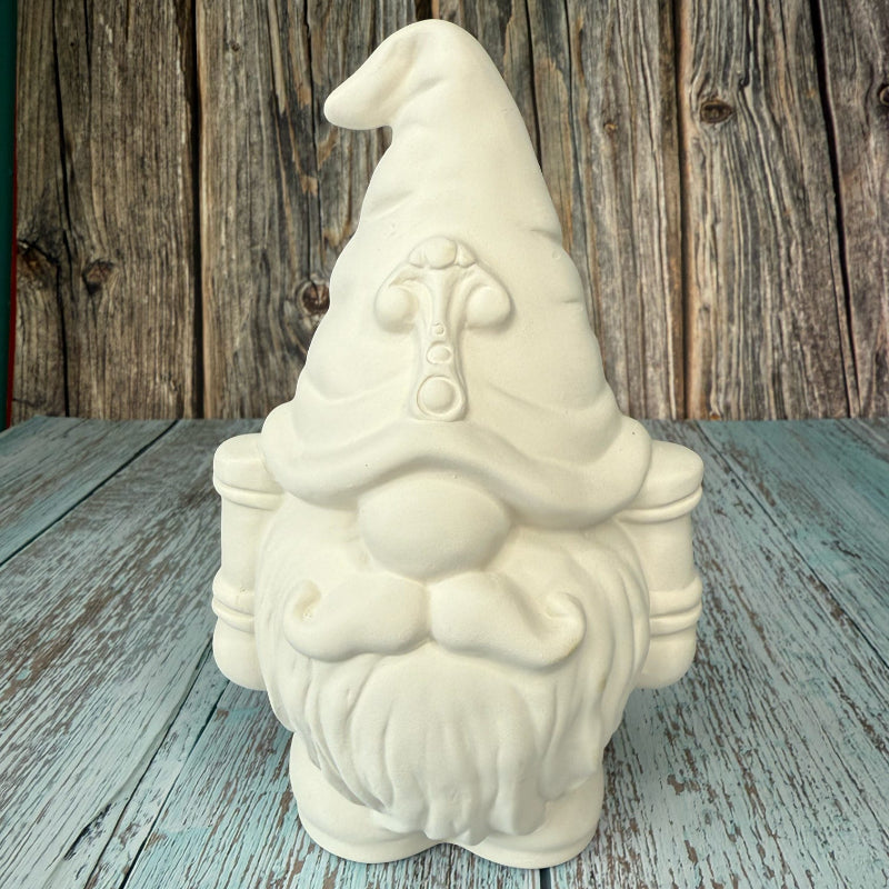 Unpainted ceramic gnome figurine on a wooden surface