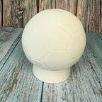 White soccer ball on a rustic wooden surface