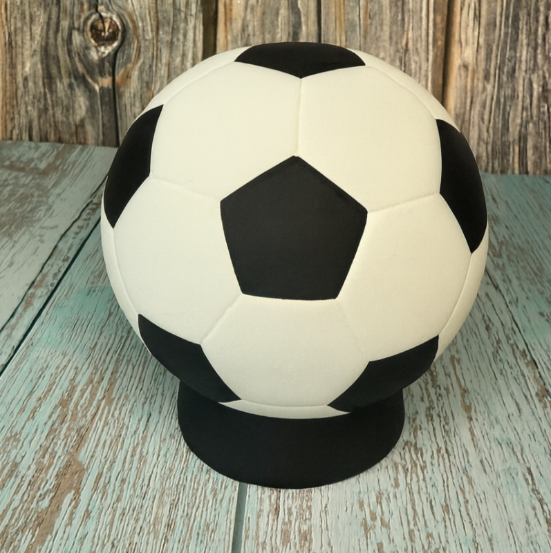Soccer ball on a stand against a wooden background