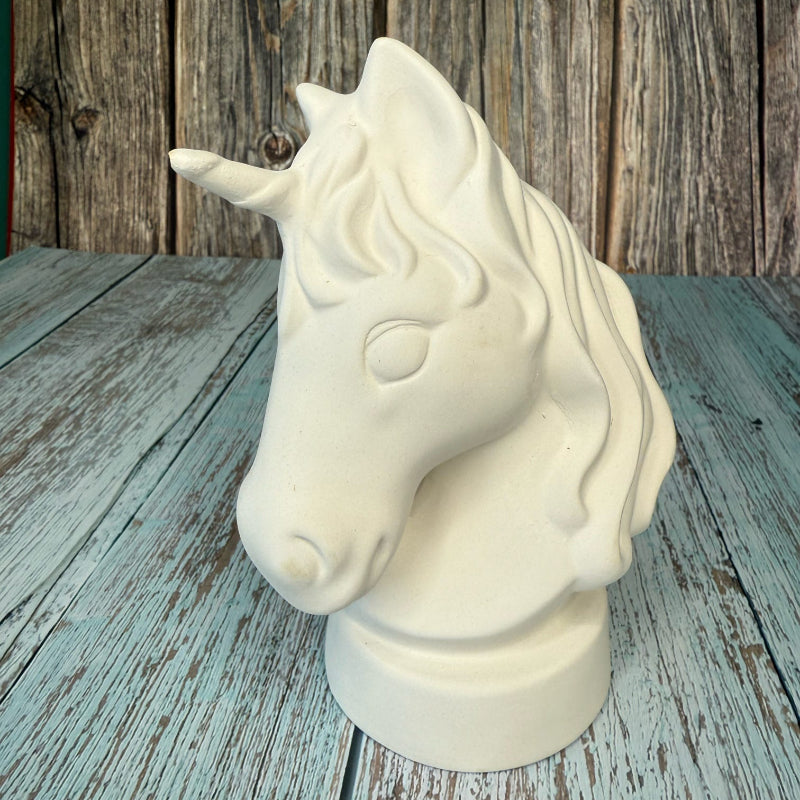 White horse bust on a wooden surface with a rustic wooden wall background