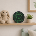 Decorative shelf with a plush bunny, green decorative plate, and plant against a light wall.