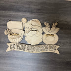 Wooden Christmas decoration with Santa Claus face and 'Christmas Gilded Welcome Here' banner on a wooden background