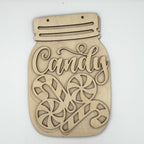 A laser-cut wooden Christmas sign shaped like a mason jar with the word 'Candy' in script and two candy cane illustrations, shown on a plain white background.
