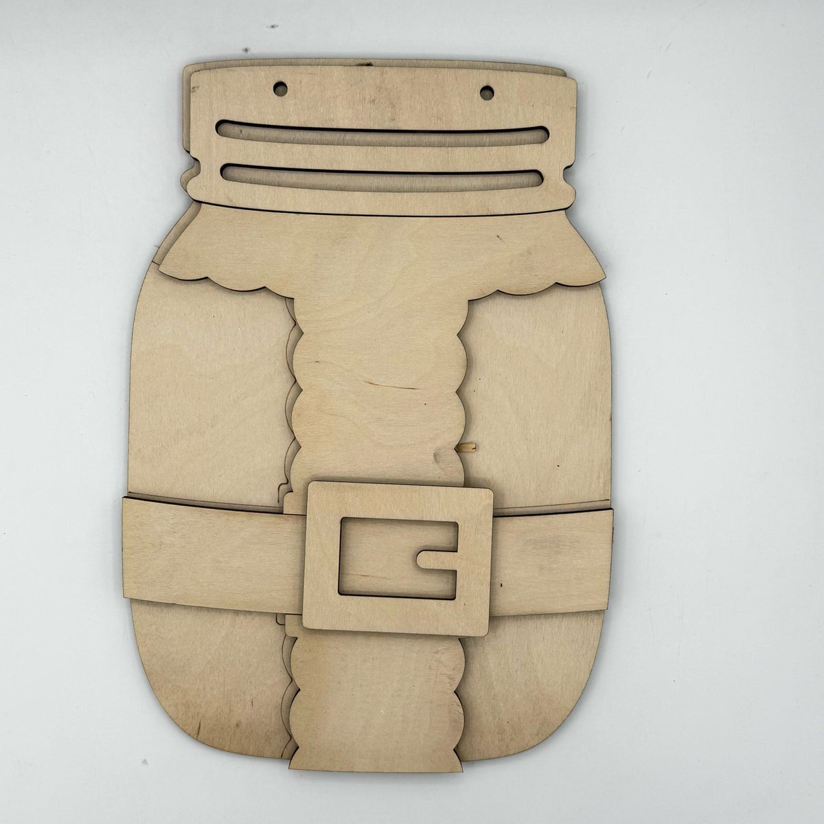 Unfinished laser-cut wooden craft piece shaped like a mason jar with a belt and buckle, made from light natural plywood on a white background.