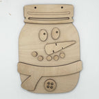 A wooden snowman face cutout or wall decor piece made from light natural wood, featuring cutout eyes, nose, buttons, and a hat, shown on a plain white background.