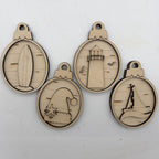 Four oval laser-cut wooden ornaments with ocean-themed designs including a surfboard, lighthouse, wave, and sailboat, displayed on a white background.
