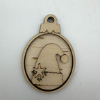 A laser-cut wooden ornament-shaped piece featuring a Santa hat silhouette with a snowflake detail, displayed on a light off-white background.