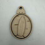 A laser-cut wooden ornament or keychain charm featuring a surfboard design inside an oval frame with a hanging loop at the top, shown on a plain off-white background.
