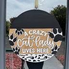 Decorative sign with 'A Crazy Cat Lady Lives Here' text on a door