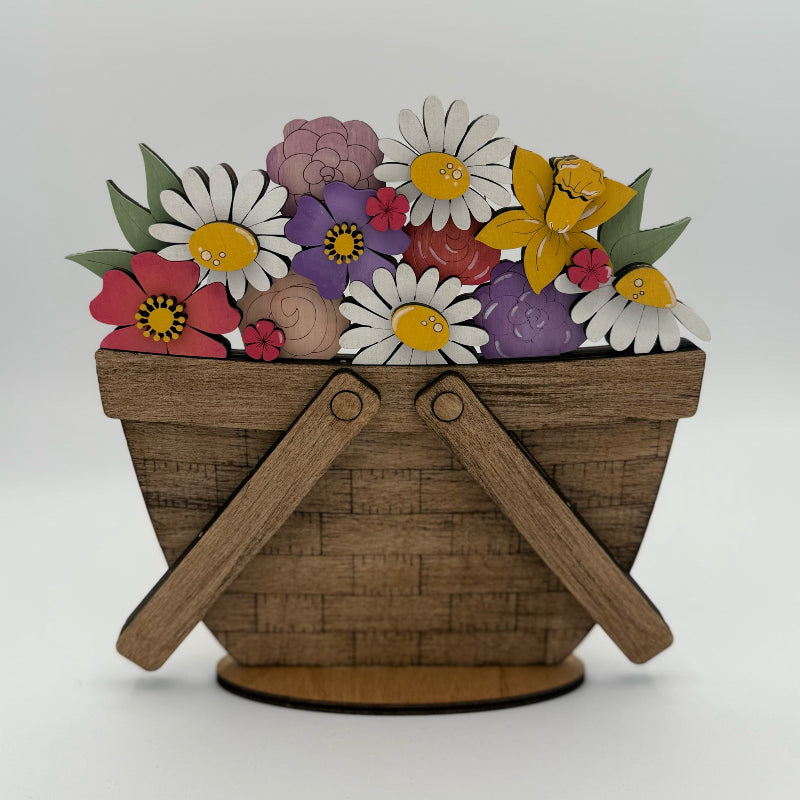Wooden basket with colorful flowers and butterflies on a white background