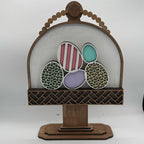 Decorative wooden stand with colorful eggs on a white background