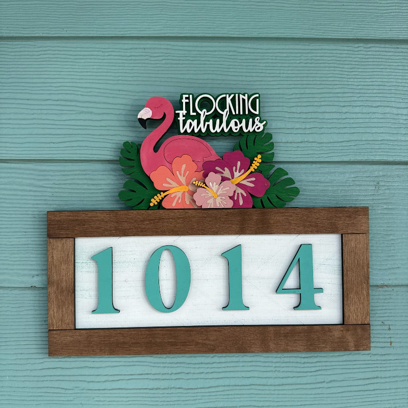 Decorative house number sign with flamingo and flowers on a teal background