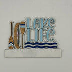 Decorative sign with 'Lake Life' text and oars on a white background