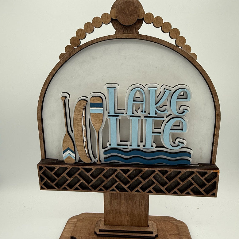 Decorative sign with 'Lake Life' text and paddle design on a white background
