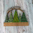 Decorative wall art with Christmas trees and 'Merry & Bright' text on a wooden background