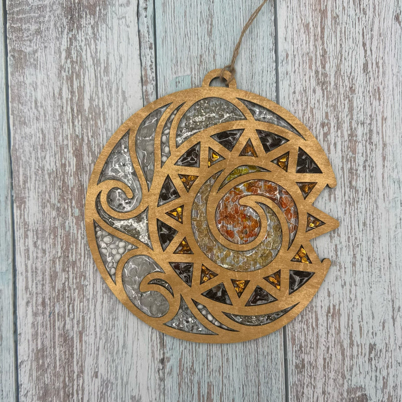 Decorative circular wall hanging with geometric patterns on a wooden surface