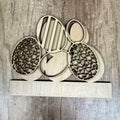 Wooden laser-cut decorative pieces on a wooden surface
