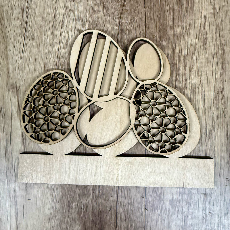 Wooden laser-cut decorative pieces on a wooden surface