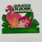 Decorative sign with pink flamingo, flowers, and 'Flocking Fabulous' text on a white background