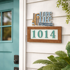 House number '1014' on a decorative sign with 'Lake Life' theme next to a teal door.