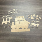 Wooden Christmas train set with 'Merry Christmas' text on a wooden surface