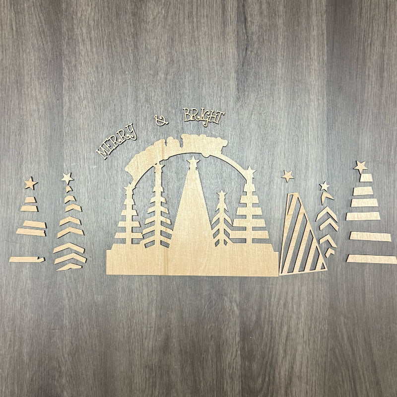 Wooden Christmas decoration with trees and arch on a wooden background