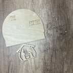 Wooden cutouts with Christmas phrases and nativity scene on a wooden surface