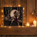 Decorative wall art with a fairy and moon design on a white background