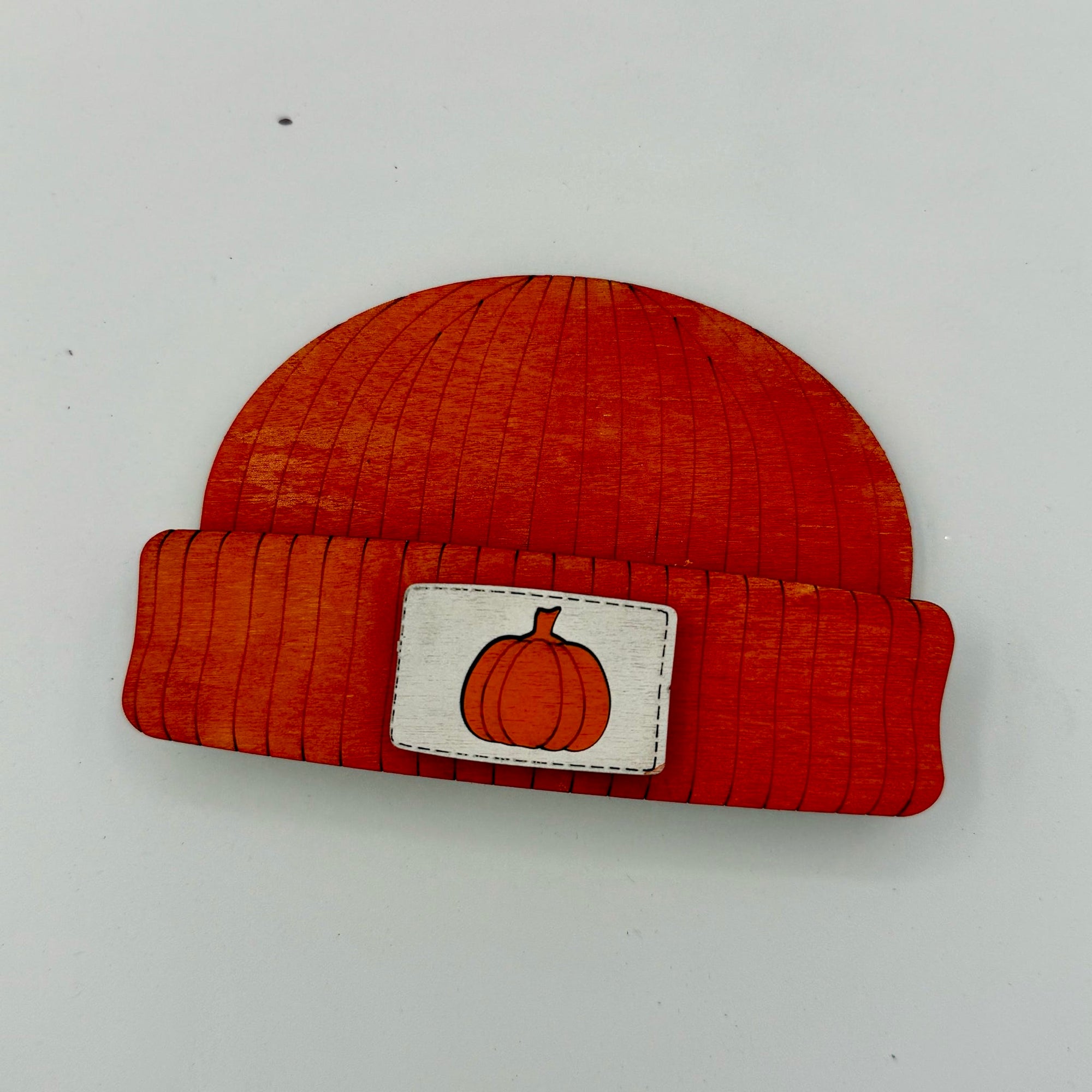 Orange beanie with a pumpkin patch on a white background