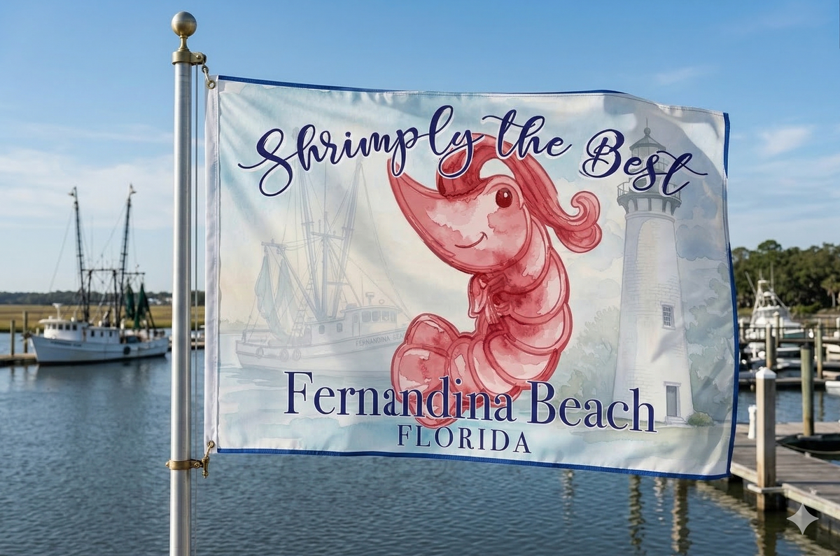 Flag with a shrimp design and text 'Shrimply the Best Fernandina Beach Florida' against a backdrop of a lighthouse and boats.
