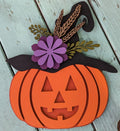 A 3D laser cut pumpkin design with a witch hat and floral details, primarily orange with black, purple, and brown accents.
